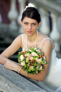 Portrait of beautiful bride holding bouquet of flowers.