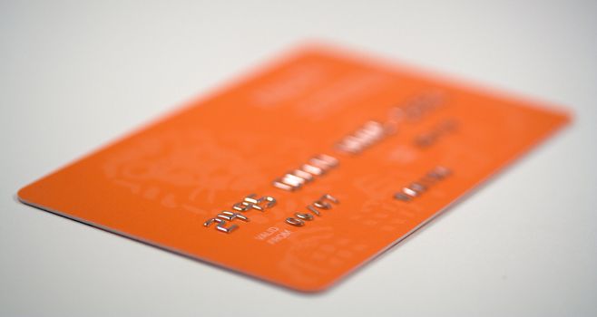 Credit card on grey background. Focus on 06 digits