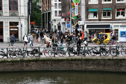 AUGUST 28, 2008: Street life in Rokin street, Amsterdam, Netherlands. Cyclists and pedestrians.