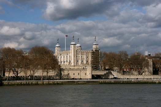 Tower of London - the medieval castle and cloudy sky. Famous architecture of Great Britain.