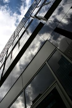 Blue sky, white clouds and modern office building in London, England