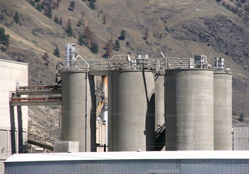 Cement factory in Canada with background mountains.