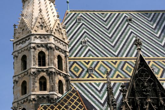 Tiled roof colorful patterns. Famous landmark in Vienna - Stephansdom.
