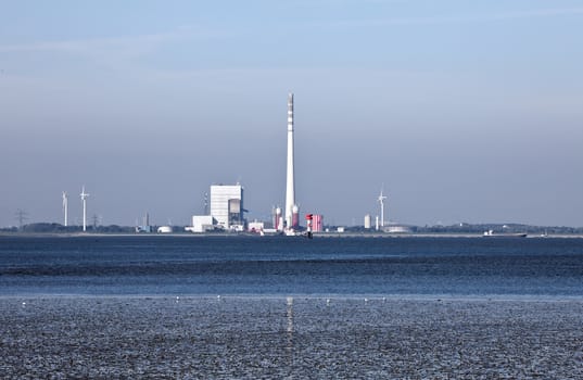 This image shows a industrial plant at north sea mudflat