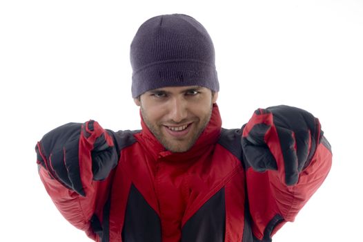 smiling handsome man pointing towards against white background