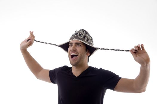 young man playing with his cap with white background