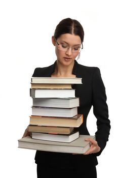 girl holding a large pile of books