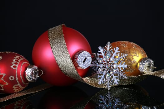 Christmas decorations on black reflective background