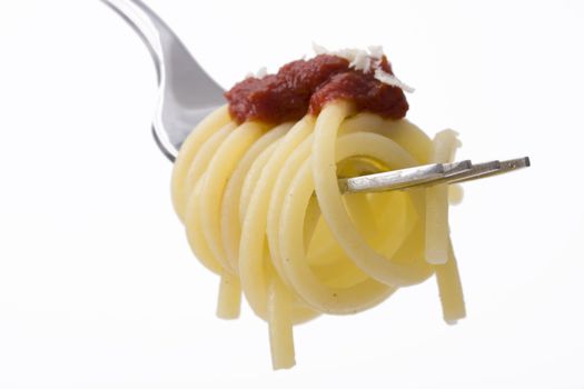 spaghetti on a fork over white background