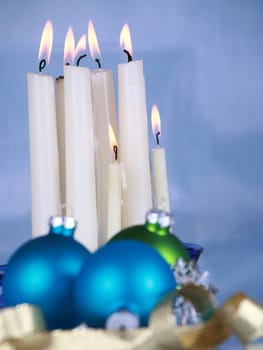 Christmas decoration on soft blue cloth, focus on candles