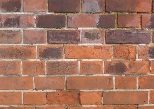 Old fashioned type red brick wall showing the sign of age