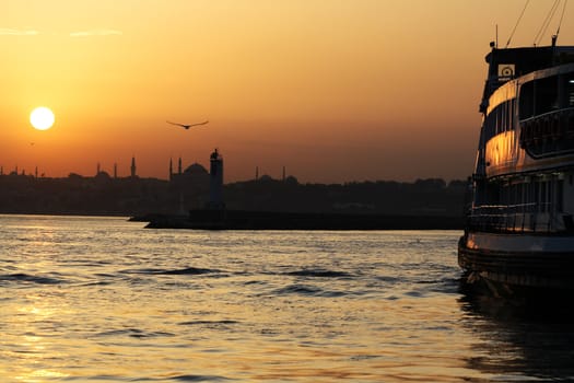 Passenger Ferry sailing across Bosporus during sunset. Istanbul, Turkey