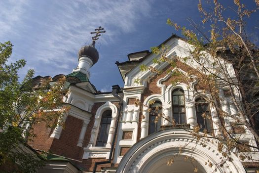 On a background of the light-blue sky church with domes.
