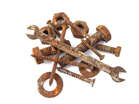 Rusty nuts, bolts, screws and spanner on a plane white background.