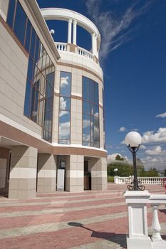 Glass facade and balcony with columns.