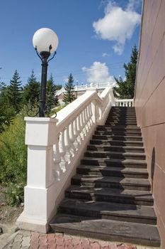 Ladder with a lantern and white balustrade.