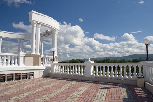 Arch with white columns on a background of the dark blue sky.