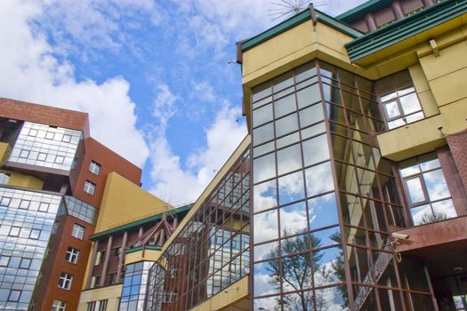 Modern building from a brick. Glass windows and balconies.