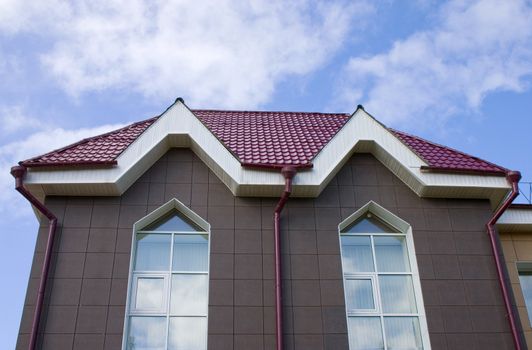 Modern building from a brick. Red tile roof.