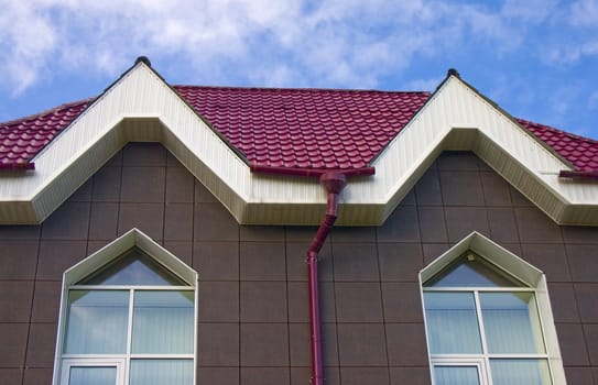 Modern building from a brick. Red roof. A tile.