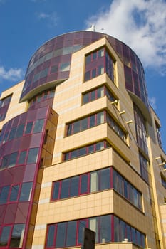 Modern building from a brick. Glass windows and balconies.