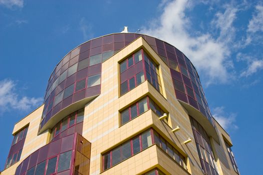 Modern building from a brick. Glass windows and balconies.