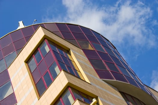 Modern building from a brick. Glass balconies.