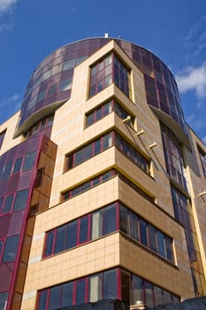 Modern building from a brick. Glass windows and balconies.