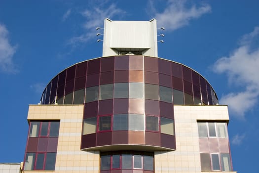 Modern building from a brick. Glass windows and balconies.