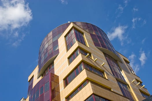Modern building from a brick. Glass windows and balconies.