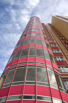 Modern building from a brick. Glass balconies.
