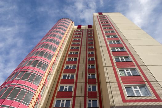 Modern building from a brick. Glass balconies.