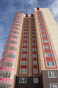 Modern building from a brick. Glass balconies.