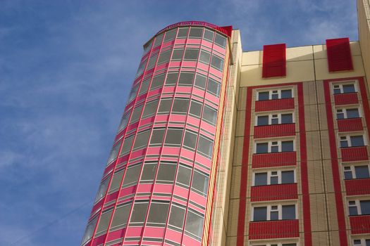 Modern building from a brick. Glass balconies.