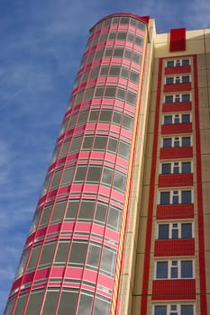 Modern building from a brick. Glass balconies.