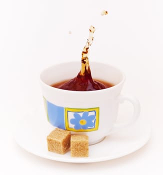 Morning tea with slices of reed sugar on white background