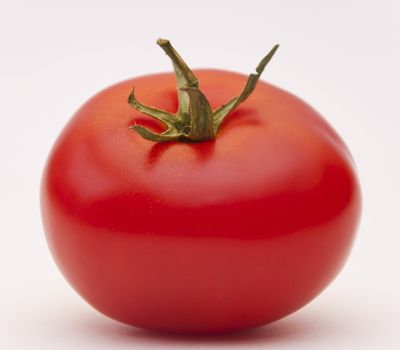 Red ripe juicy tomato on white background