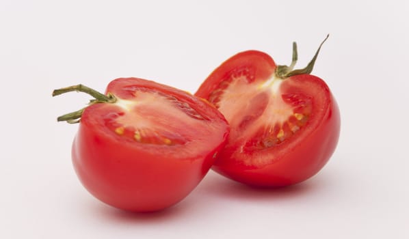 Halves of the Mature Tomato on the White Way with Breakage