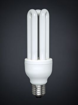 Compact fluorescent light bulb over a gray background.