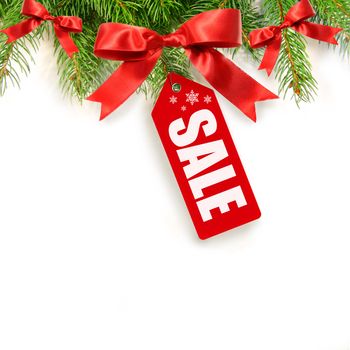 Pine branches,bows and sales tag isolated on white