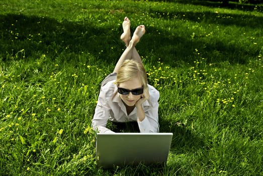young woman working outside on computer
