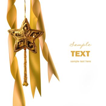 Gold christmas star with ribbons against dark background