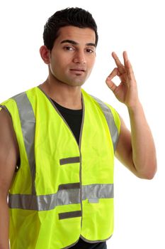 Ethnic mixed race, blue collar man such as a builder, tradesman, labourer, handyman gestures a positive a-ok approval hand sign gesture.  White background.