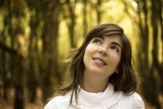 Beautiful happy woman in the autumn park