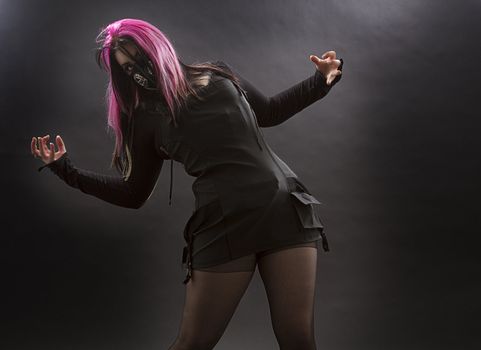 maniacal looking goth girl with pink hair and body piercing