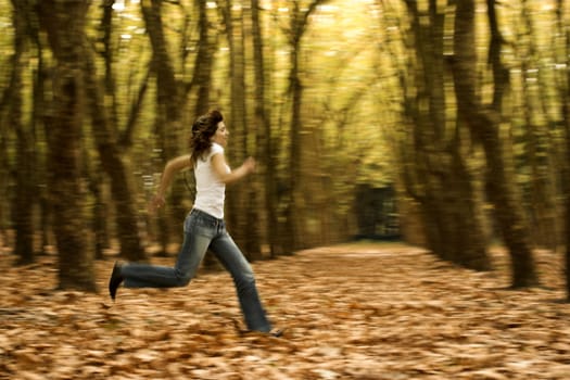 Woman runing in the Autumn Park -  Intentional blured efect