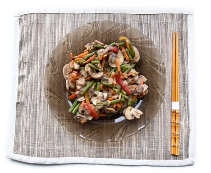Plate with grilled vegetables and chopsticks. White background, isolated.