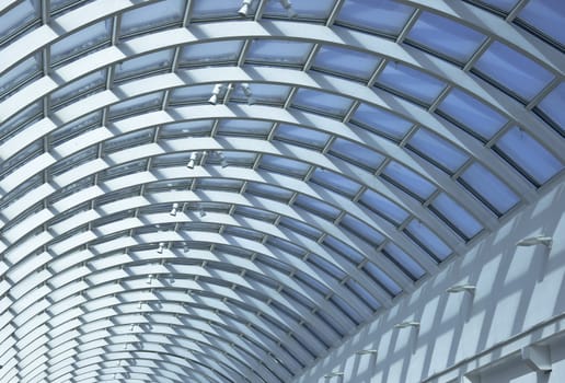 Detail of public interiors. Ceiling light atrium through the translucent roof. Clear shadows and light.