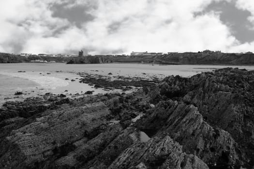 a rocky beach on a warm day with a calm sea an ideal place to have a walk in ireland