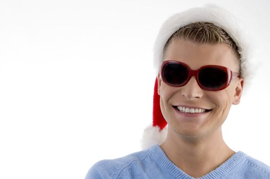 smiling young man with christmas hat wearing sunglasses with white background